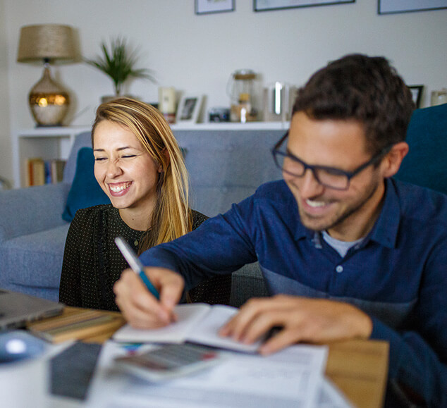 happy couple paying bills