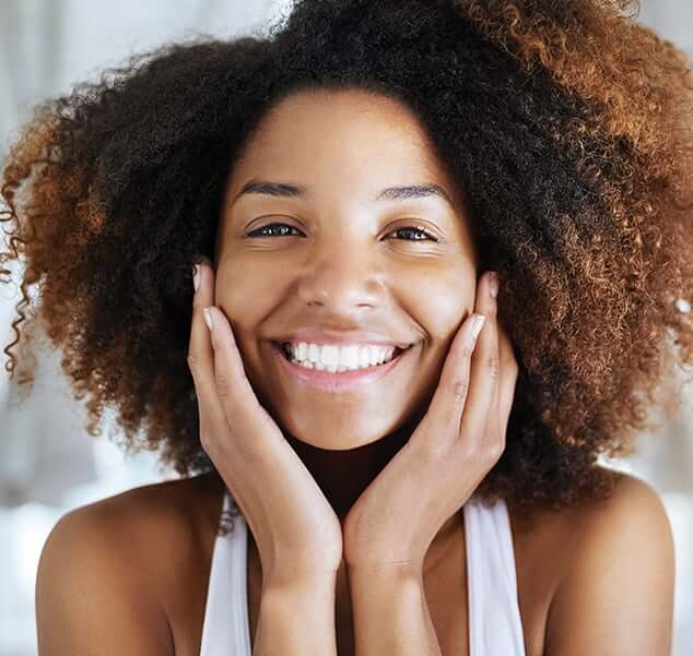 smiling woman holding her face