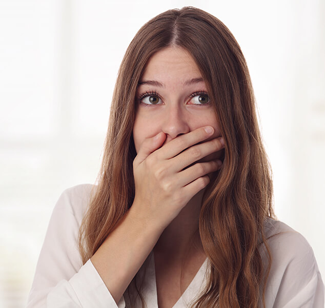 woman covering her mouth with her hand