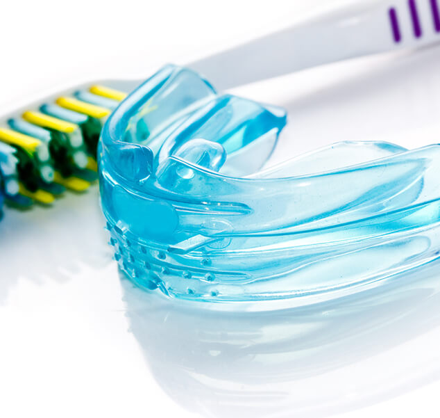 mouthguard next to a toothbrush